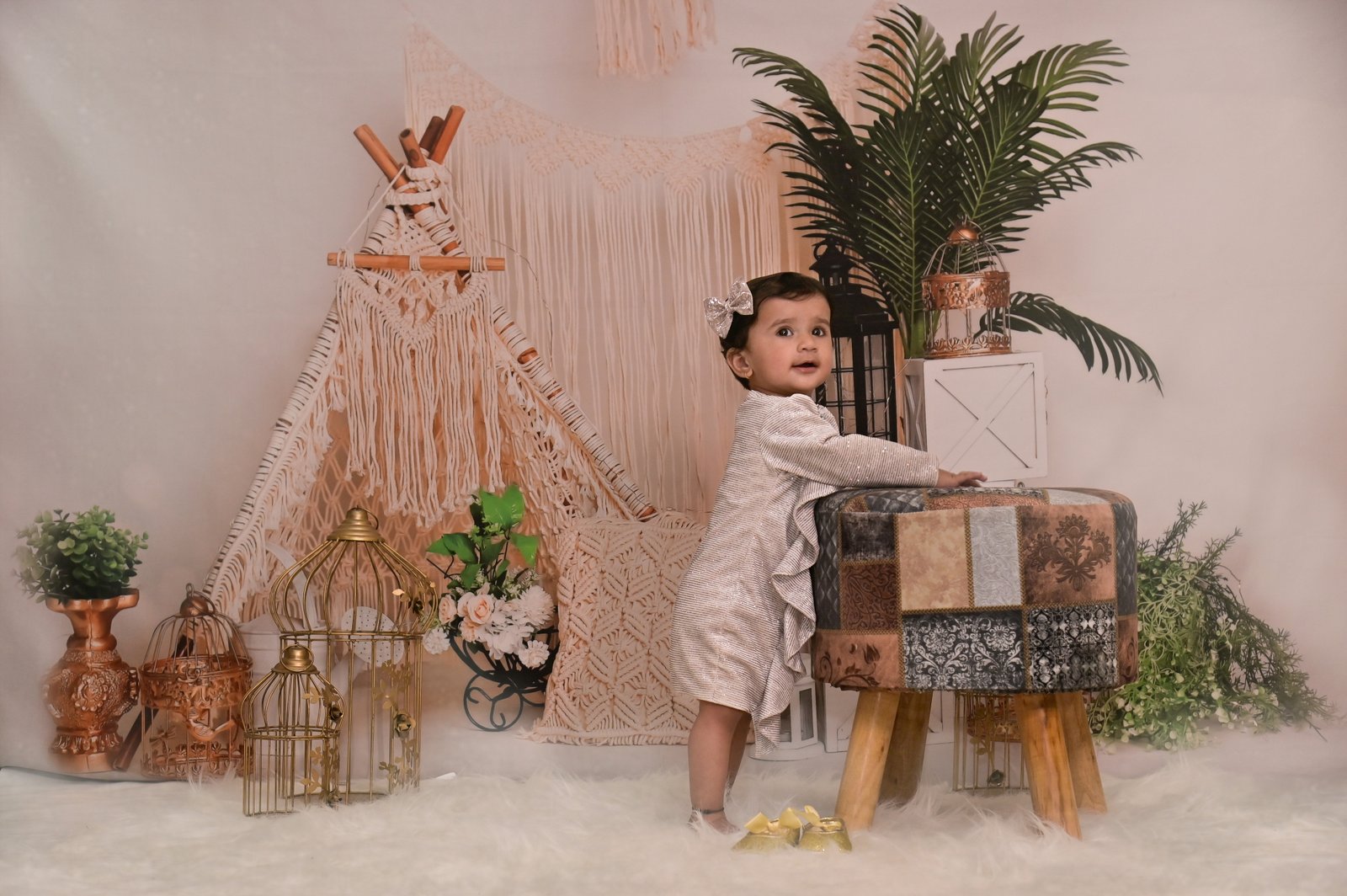 Baby standing among elegant bohemian studio props Baby standing among elegant bohemian studio props