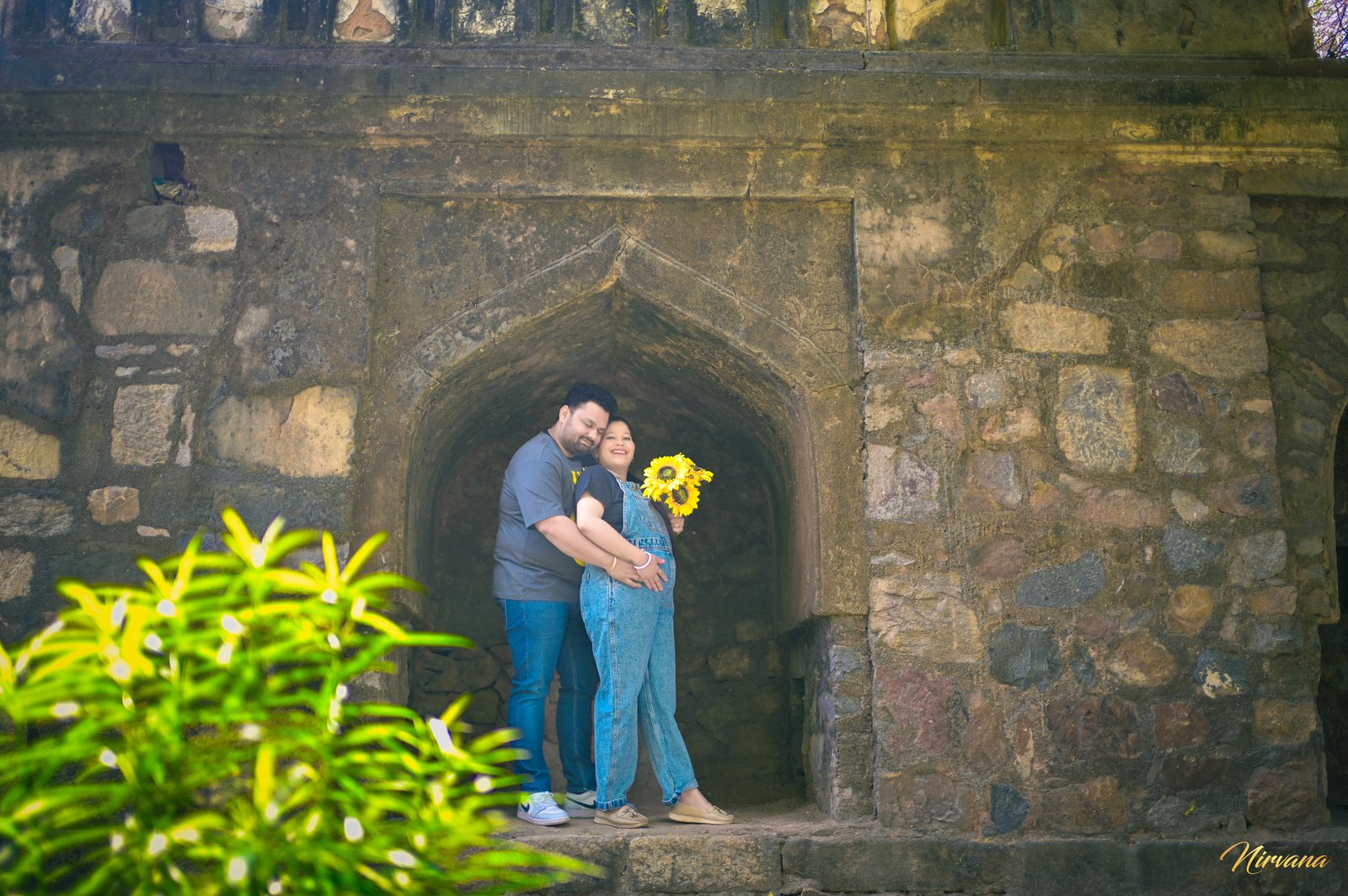 Expecting parents embracing during an outdoor maternity session Expecting parents embracing during an outdoor maternity session
